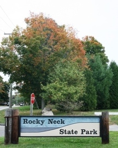 The Rocky Neck State Park sign in the fall
